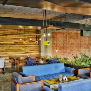 A contemporary café in Ahmedabad showcasing modern furniture and industrial elements.
